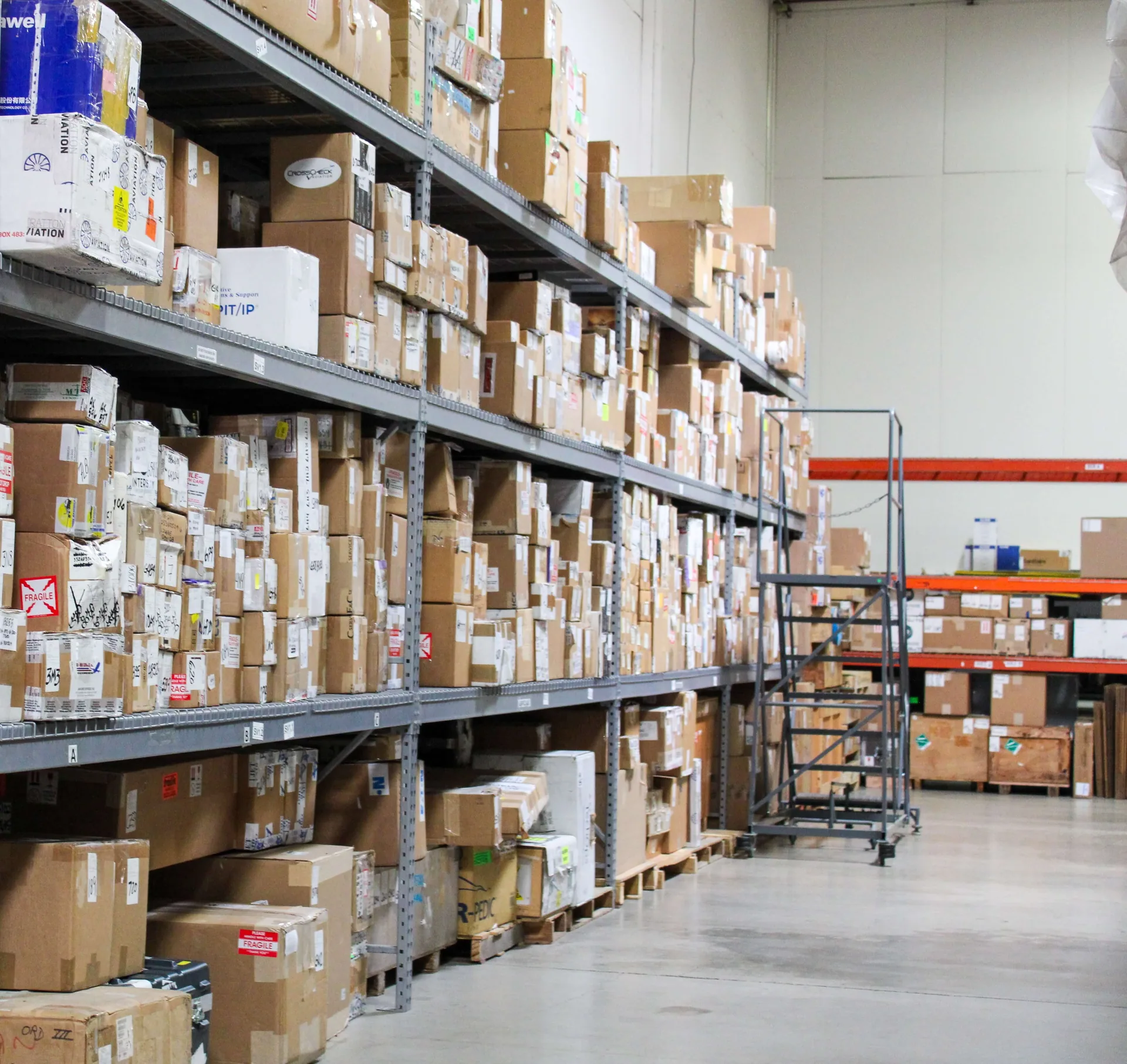 Rows of labelled aircraft parts on warehouse shelving